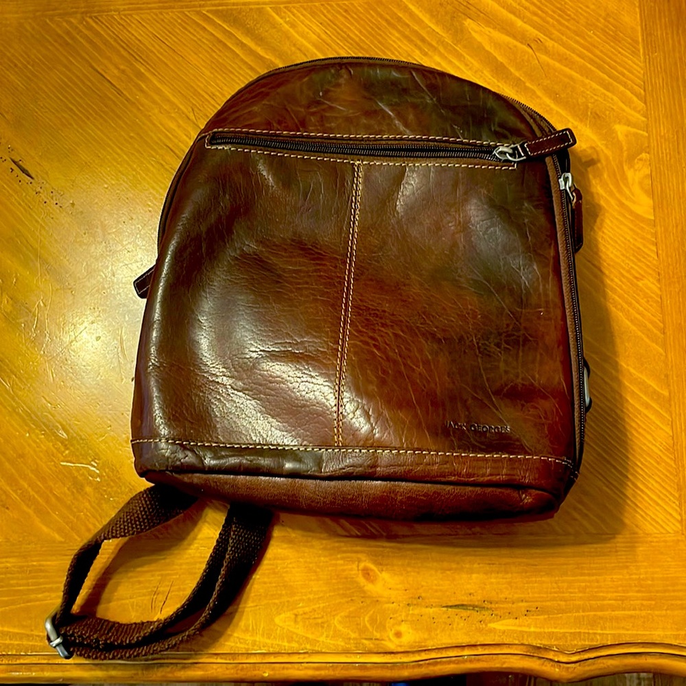 Jack George. LEATHER. Front pocket. Back pack style. Used. Good condition.